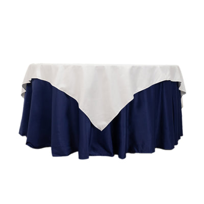 Navy tablecloth with white overlay for elegant dining settings