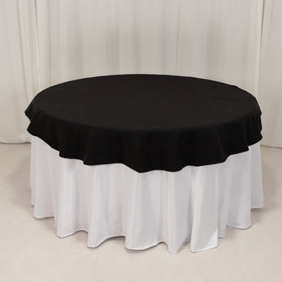 Black round tablecloth with white skirt for elegant dining setups.