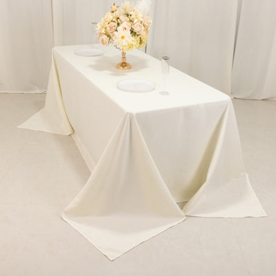 Elegant white tablecloth draped over a table with floral centerpiece.