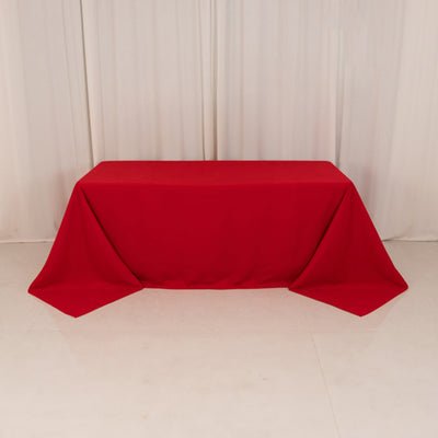 Red tablecloth draped elegantly over a table in a studio setting.