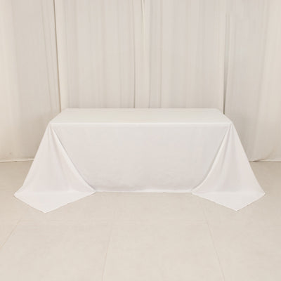 White tablecloth draped over a table in a studio setting.