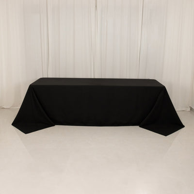 Black tablecloth draped over a table in a studio setting.