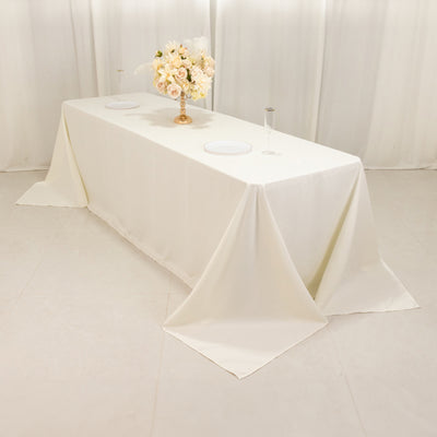 Elegant white tablecloth draped over a banquet table with a floral centerpiece.
