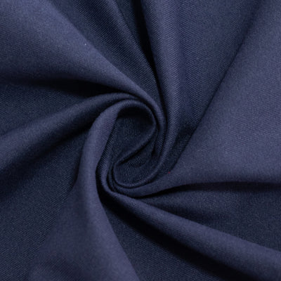 Navy blue fabric in a swirling texture close-up shot.