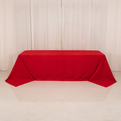 Red tablecloth draped elegantly over a table in a studio setting.