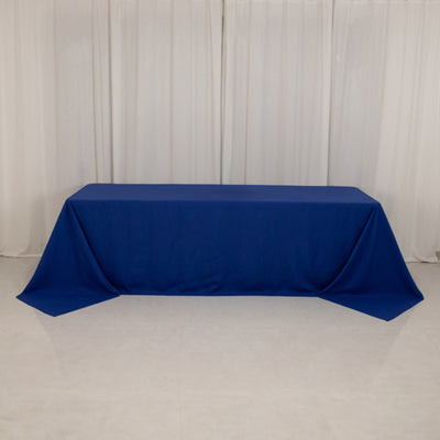Blue tablecloth draped over a table against a neutral backdrop.