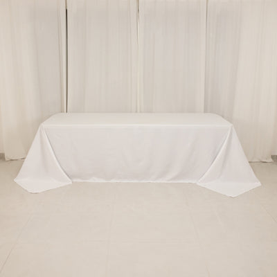White tablecloth draped elegantly over a table in a minimalistic setting.