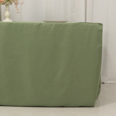 Green table cover on a table in a minimalist setting.