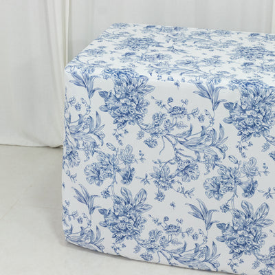 Floral-patterned table cover in blue and white on a plain background.
