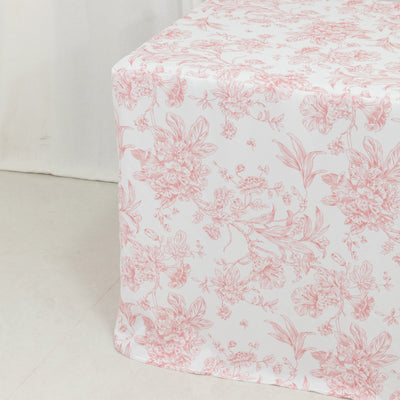 Floral patterned tablecloth with pink and white design on a plain background.