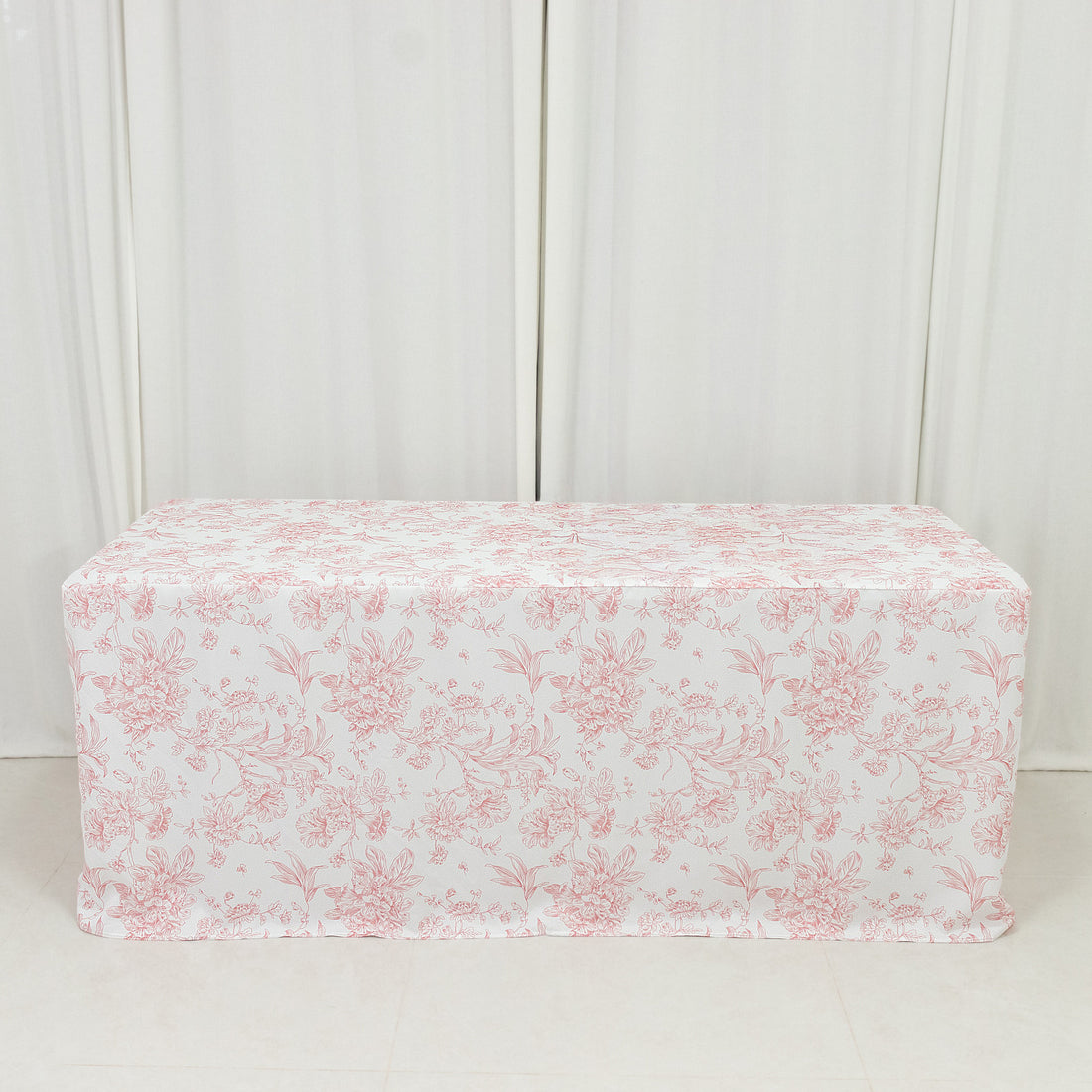 Floral patterned tablecloth draped over a table in a studio setting.
