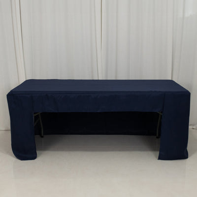 Navy tablecloth draped over a folding table in a studio setting
