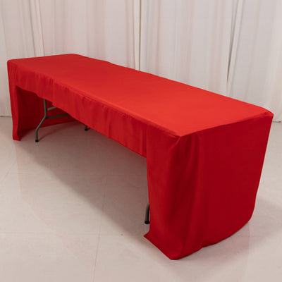 Red tablecloth draped over a folding table in a studio setting.