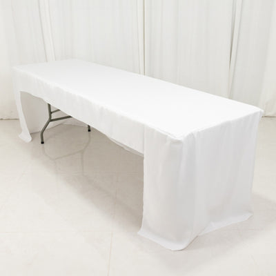 White tablecloth draped over a folding table in a studio setting