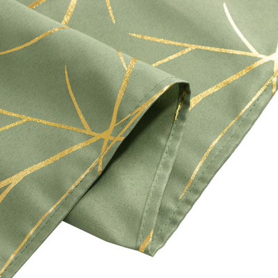 Green tablecloth with gold leaf design, showcasing elegant fabric texture.