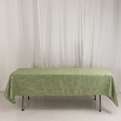 Green tablecloth with gold leaf design on a table