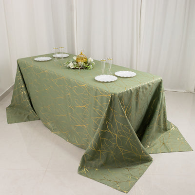 Elegant green tablecloth with gold leaf pattern draped over a table.