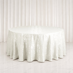 Elegant round white table with satin tablecloth in a minimalist setting