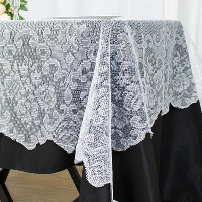 Elegant lace tablecloth with black base, perfect for dining decor.