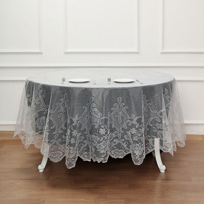 Elegant lace tablecloth draped over an oval dining table.
