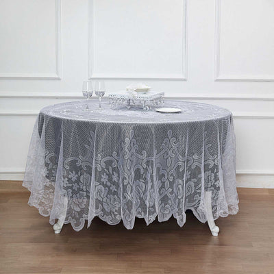 Elegant lace tablecloth draped over a round table in a stylish setting.