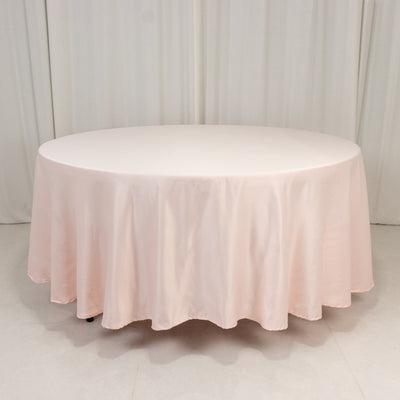 Round pink tablecloth draped elegantly on a circular table