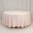 Round pink tablecloth draped elegantly on a circular table