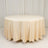 Round beige tablecloth on a plain backdrop.