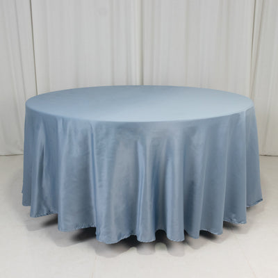 Round blue tablecloth with elegant draping fabric.