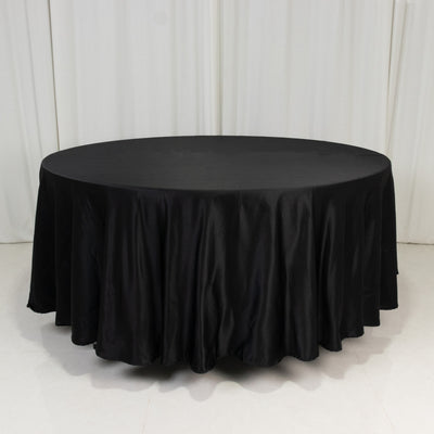Black round tablecloth with elegant draping, ideal for events and dining.