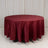 Round burgundy tablecloth on a plain backdrop