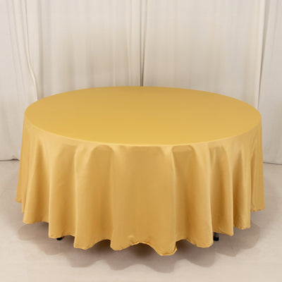 Round yellow tablecloth on a circular table in a studio setting.