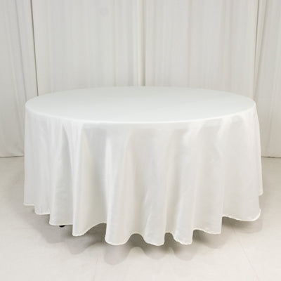 White round table covered with a smooth tablecloth