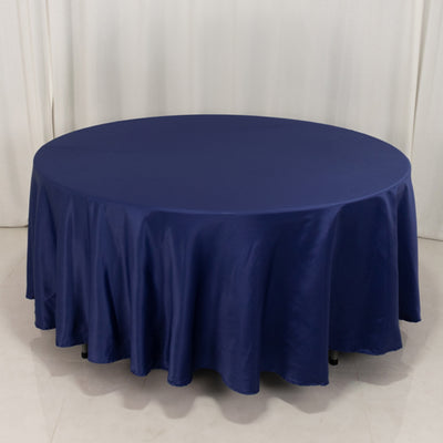 Round navy tablecloth with elegant draping for events and dining.