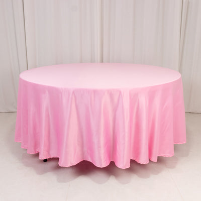 Round pink tablecloth draping elegantly over a circular table