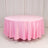 Round pink tablecloth draping elegantly over a circular table