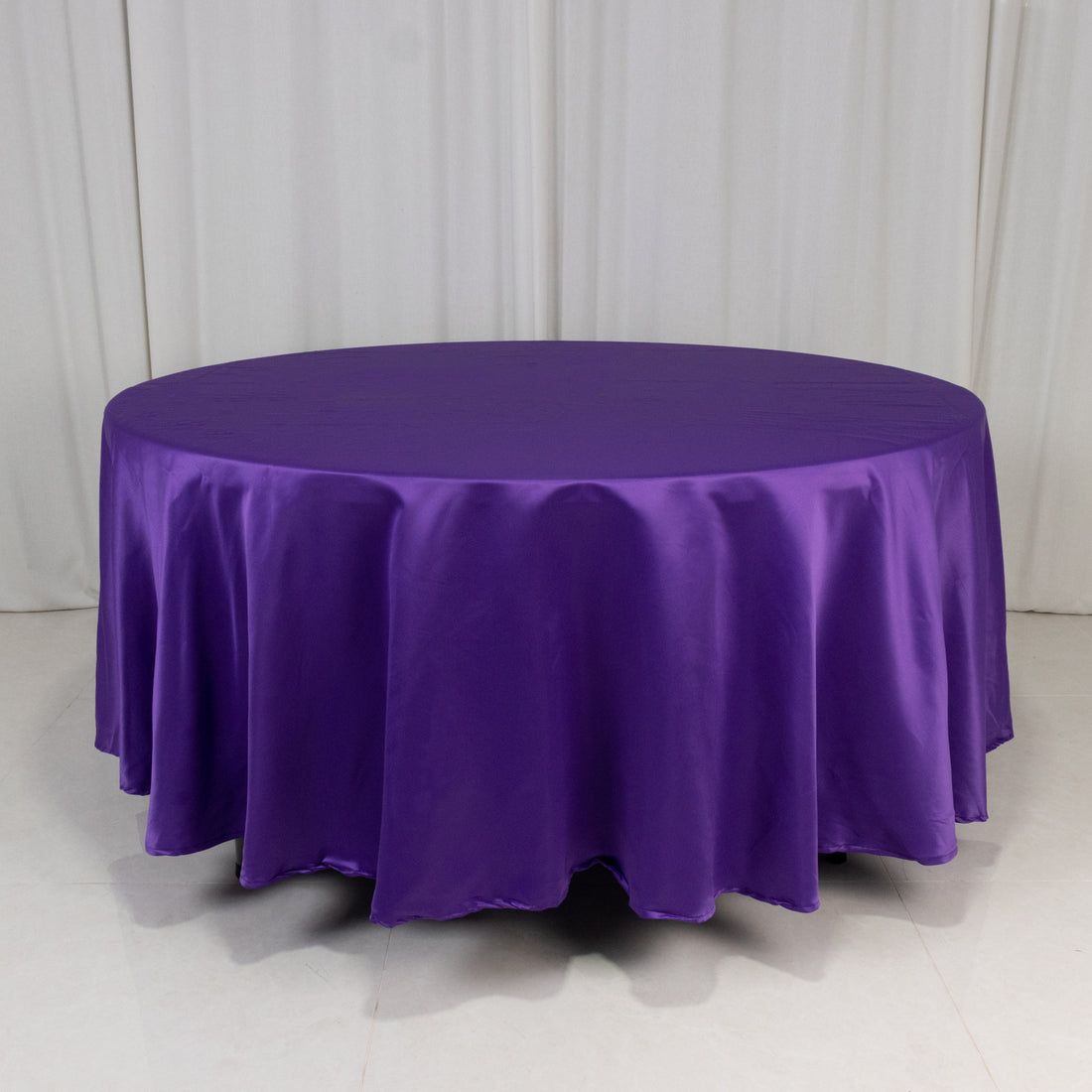 Purple round tablecloth draped elegantly over a circular table