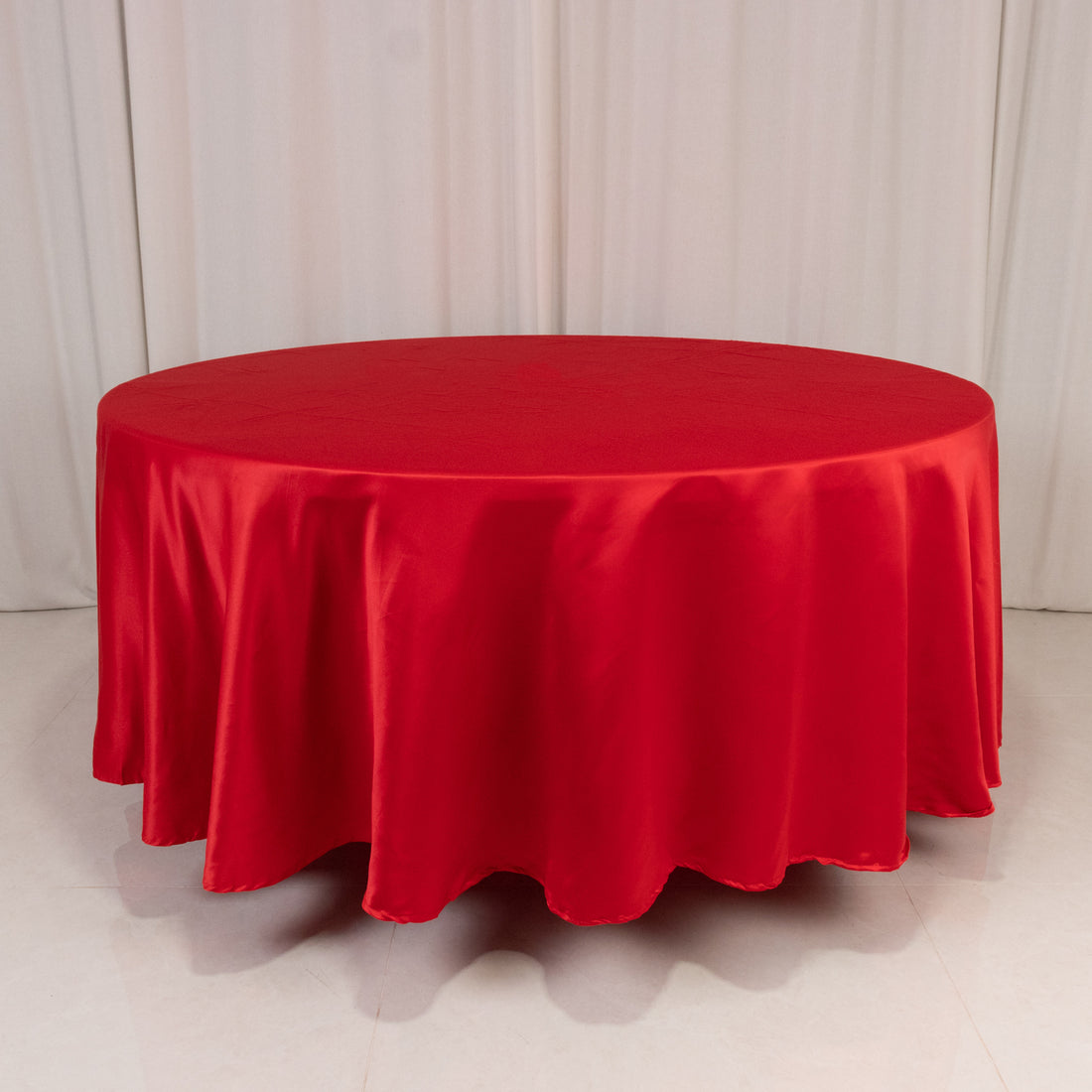 Red round tablecloth, ideal for events and dining settings.