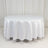 Round white table with a smooth tablecloth in a studio setting