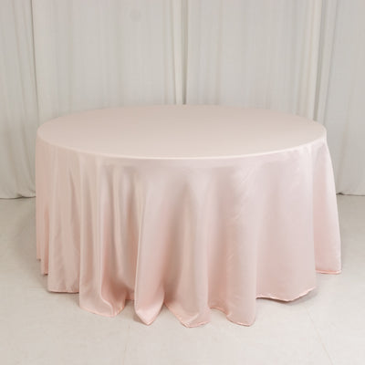 Round pink tablecloth draped elegantly on a round table.