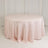 Round pink tablecloth draped elegantly on a round table.