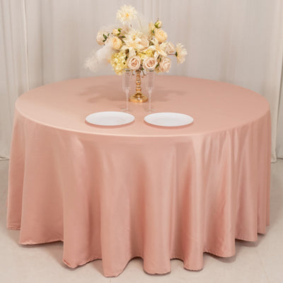 Round table with pink tablecloth and floral centerpiece