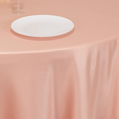 Elegant pink tablecloth with a white plate and gold rim.