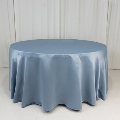 Round blue satin tablecloth draped elegantly on a circular table.