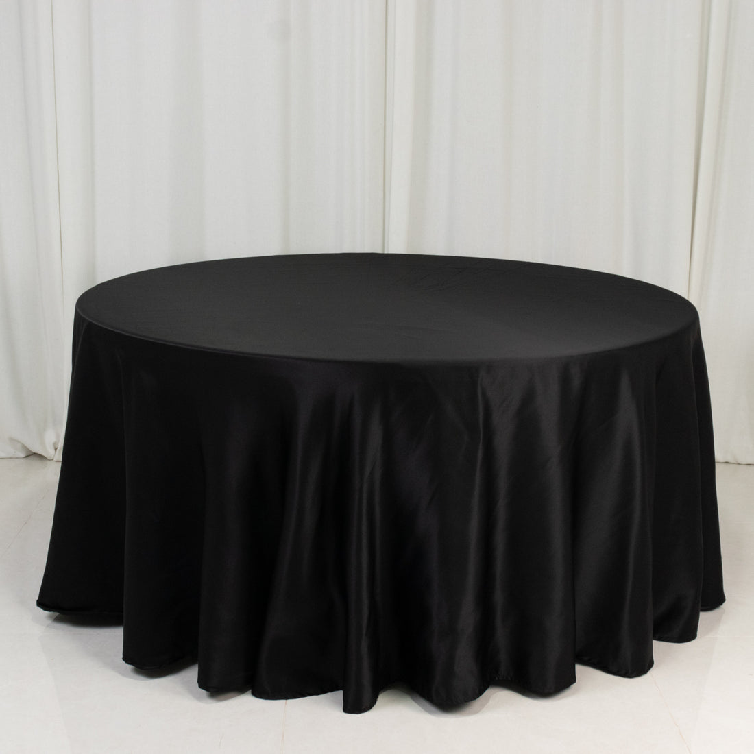 Black round tablecloth draped elegantly over a table.