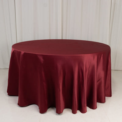 Burgundy round tablecloth draping elegantly over a table