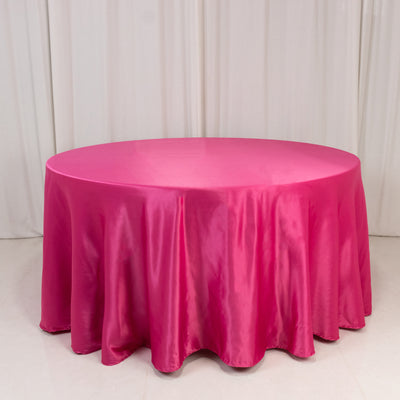 Round pink satin tablecloth draped on a round table