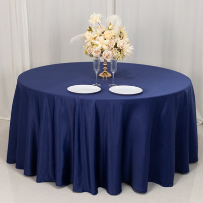 Navy round tablecloth with elegant floral centerpiece and plates