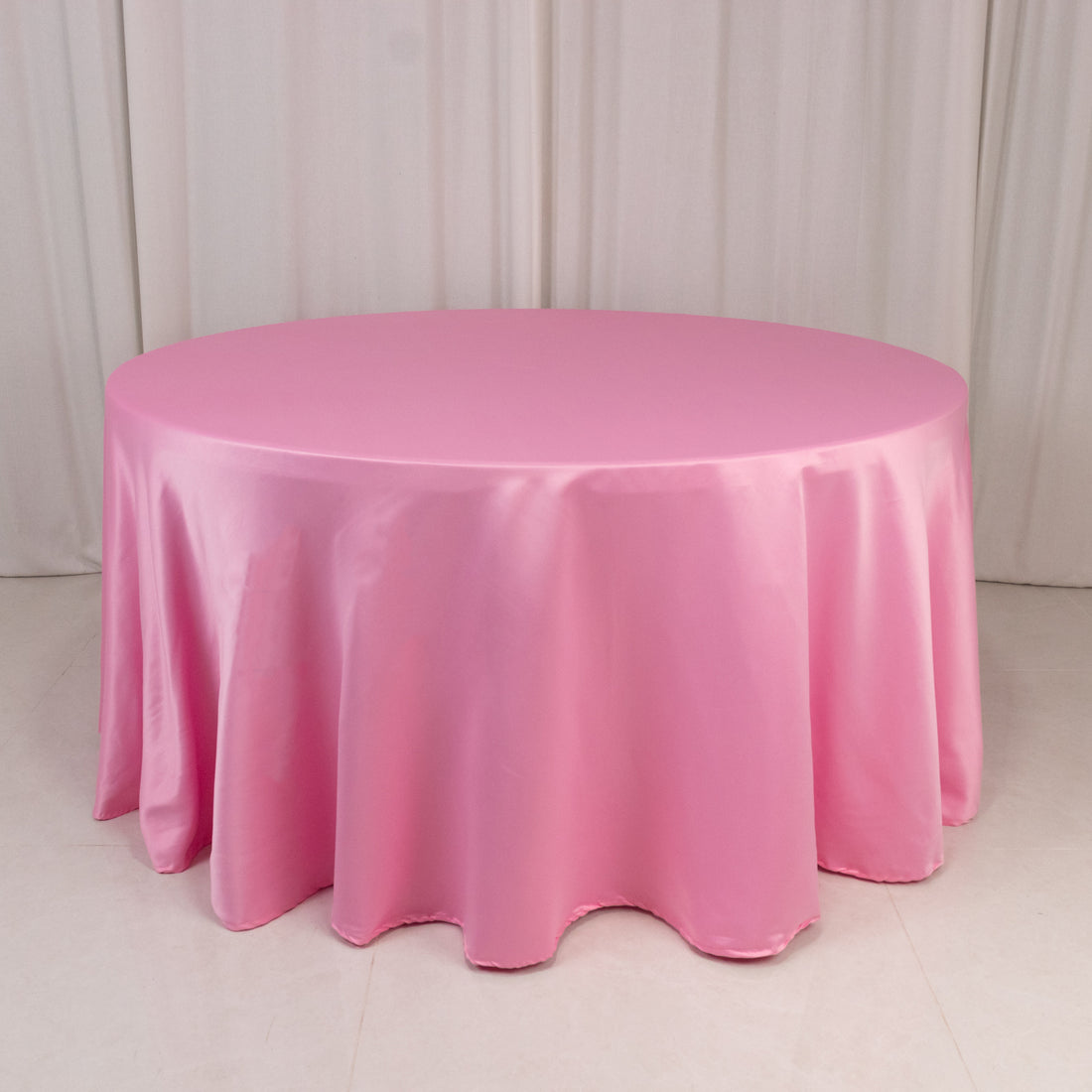 Pink round tablecloth draped elegantly over a table