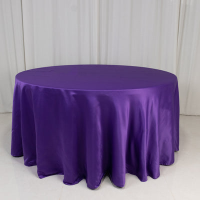 Purple round tablecloth on a white backdrop.